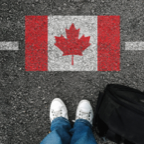 Person standing by street drawing of Canadian flag for Empowerment Squared