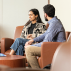 Two people sitting and discussing the Human Book Collection